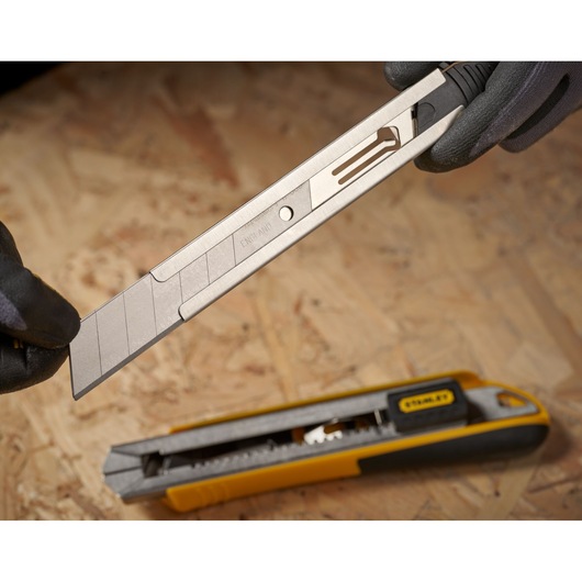 STANLEY 0-11-325 snap-off blade utility knife with segmented replacement blade on work surface.