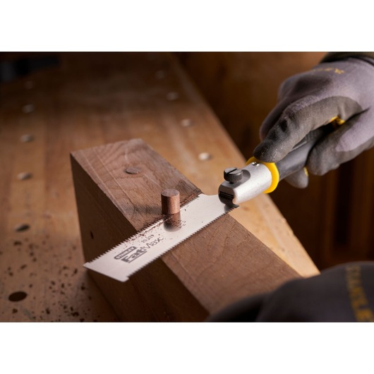 STANLEY 0-20-331 flush cut saw cutting wooden dowel on workbench, close-up angle.