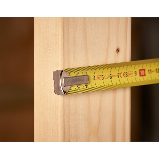 STANLEY 0-33-195 tape measure photography showing yellow blade measuring wood.