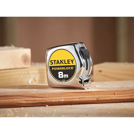 Stanley PowerLock 0-33-198 tape measure, 8m, yellow and silver, photo on wooden planks.