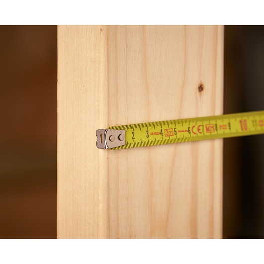 STANLEY 0-33-238 tape measure measuring a wooden plank, close-up photography.