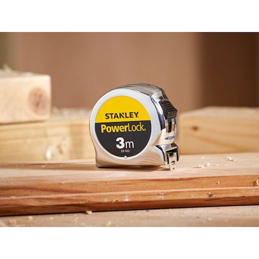 STANLEY 0-33-522 PowerLock 3m tape measure on wooden surface, close-up photography.