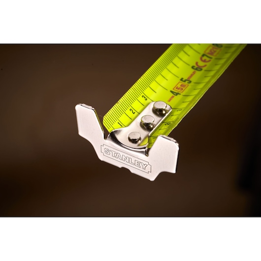 STANLEY 0-33-887 tape measure close-up showing yellow metric blade and metal end hook.