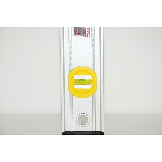 STANLEY 0-43-625 spirit level front angle, silver body, yellow vial housing, photography.