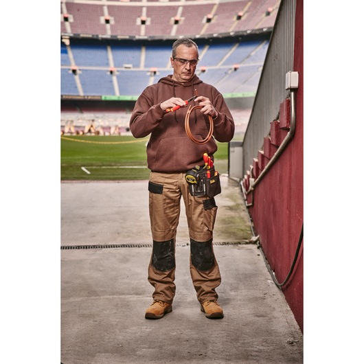 STANLEY 0-84-004 hand tools in holster on technician’s belt, stadium background, front angle.