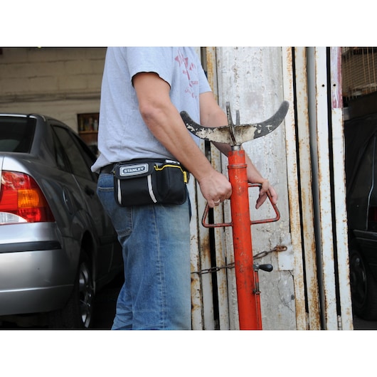 STANLEY 1-96-179 tool pouch worn on waist, photo of pouch in garage setting.