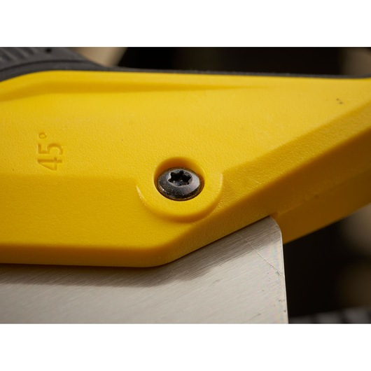 Photo of STANLEY 2-15-289 hand saw handle close-up showing yellow plastic and metal blade at a 45-degree angle.