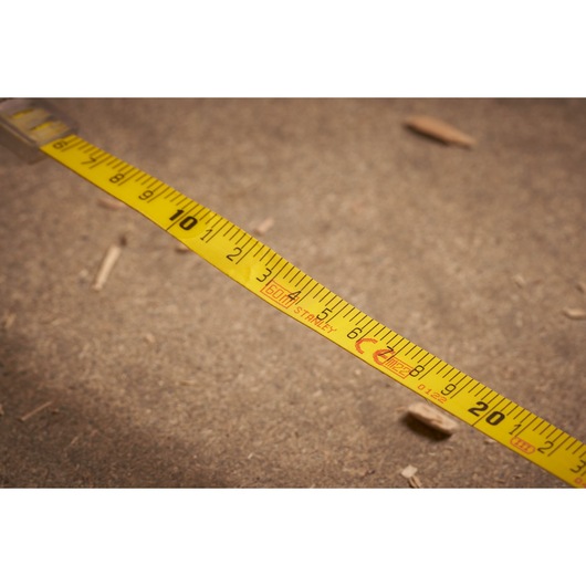 STANLEY 2-34-775 yellow tape measure photography, close-up showing measurement markings.