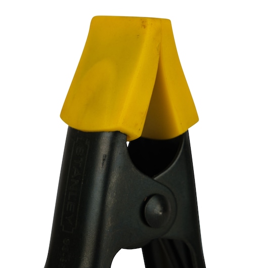 STANLEY 9-83-079 heavy-duty spring clamp with yellow plastic jaws, close-up on white background.