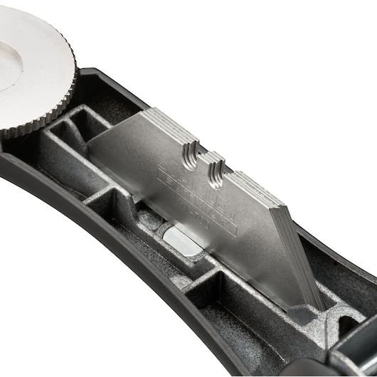 STANLEY FMHT10500-0 utility knife with exposed metal blade stack, close-up on storage compartment, white background.