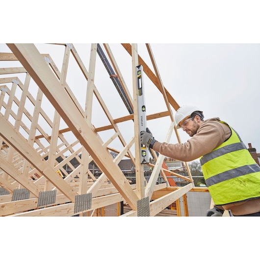 STANLEY FMHT43675-1 spirit level in use on timber frame construction site.