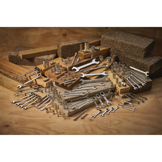 STANLEY FMMT13033-0 photography of assorted steel wrenches and sockets displayed on wood and concrete.