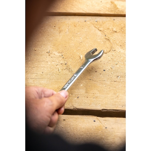 Photo of STANLEY FMMT13070-0 open-end wrench held over wooden surface, tool category.