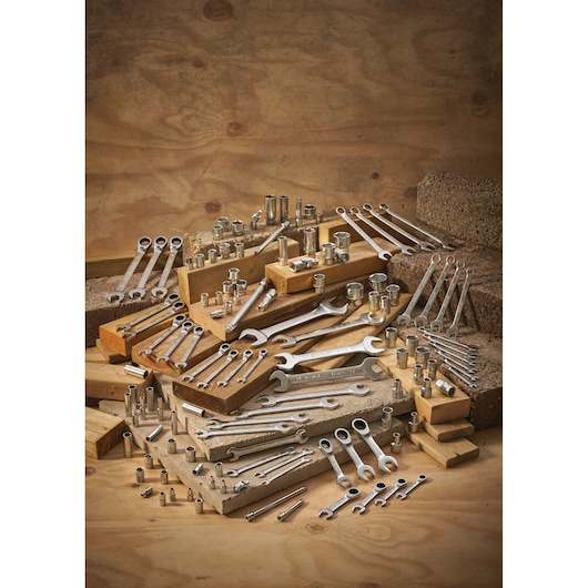 STANLEY FMMT13082-0 assorted wrenches and sockets displayed on wood blocks, workshop photography.