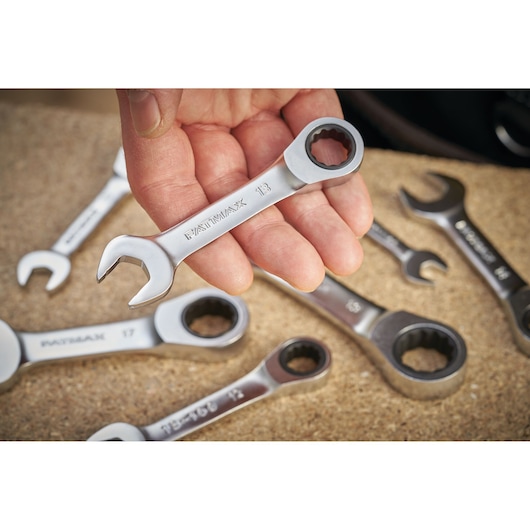 STANLEY FMMT13098-0 ratcheting combination spanner set, close-up with hand holding one wrench, other wrenches visible.