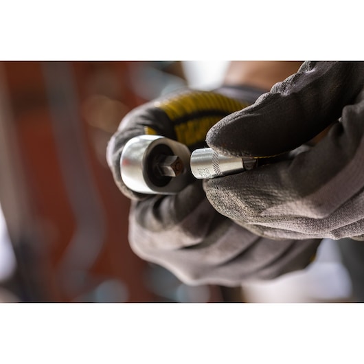 STANLEY FMMT17193-0 socket wrench held by gloved hand, close-up, photography product category.