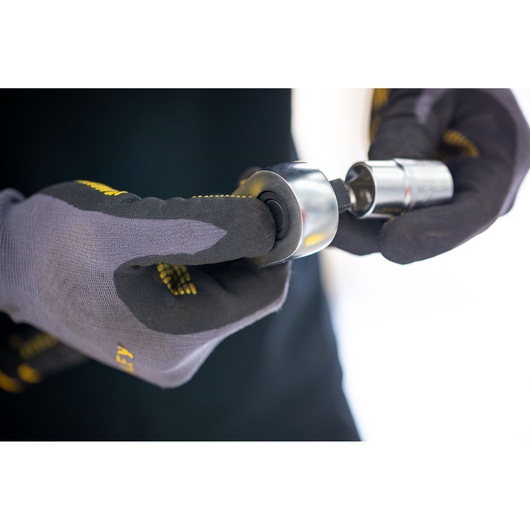 Photo of gloved hands holding a STANLEY socket tool, SKU FMMT17212-0, from the Photography category.