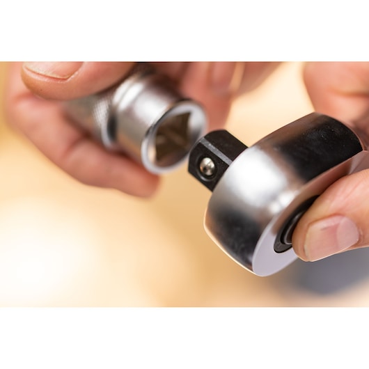 STANLEY FMMT17216-0 socket ratchet held in hand, close-up showing metal finish and square drive.
