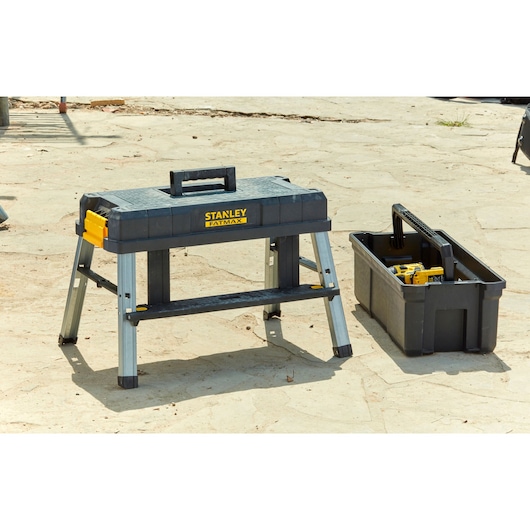 STANLEY FMST81083-1 portable workbench and tool box outdoors, black and yellow, photography of product.