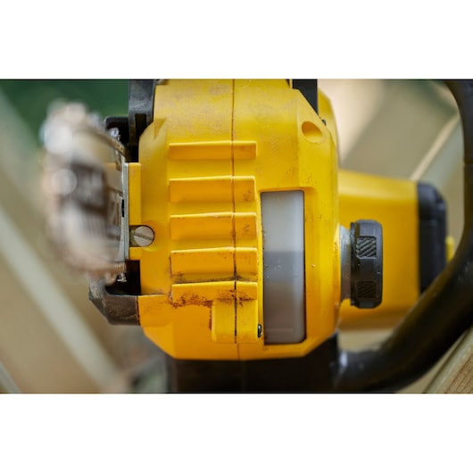STANLEY SFMCCS730B chainsaw side close-up showing yellow casing and adjustment knob.
