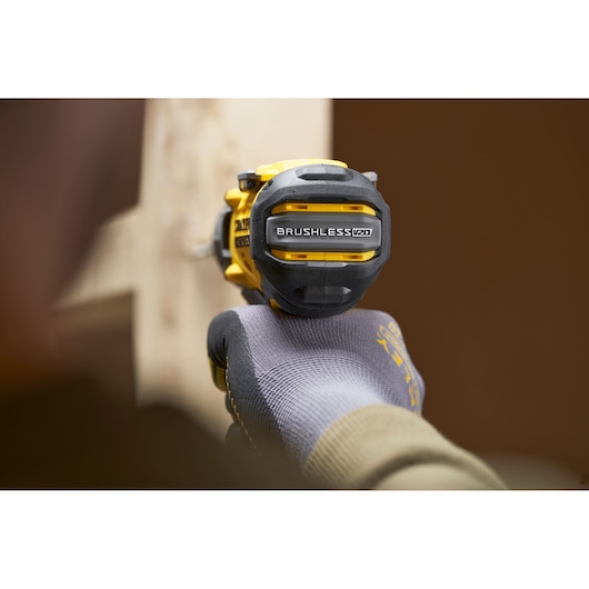Stanley SFMCD726B brushless drill rear close-up, showing V20 branding, held by a gloved hand.
