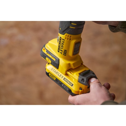 STANLEY SFMCE500D2K yellow cordless drill close-up showing battery attachment.
