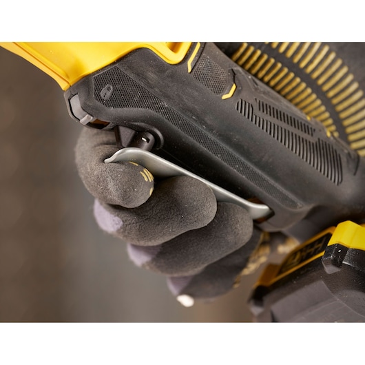STANLEY SFMCF930B cordless drill close-up, gloved hand gripping black and yellow handle.