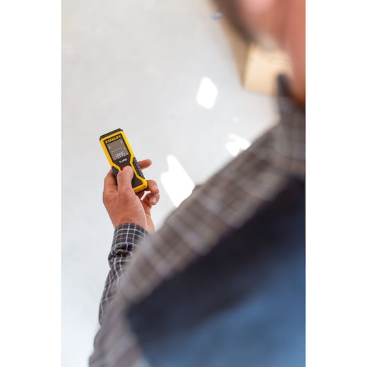 STANLEY STHT1-77409 laser distance meter held in hand, close-up photography.