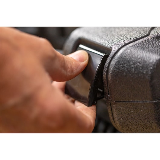STANLEY STMT82831-1 close-up photo of a hand opening a black latch on a textured tool case.