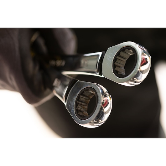 STANLEY STMT89912-0 ratcheting wrenches close-up held by gloved hand, shiny chrome finish.