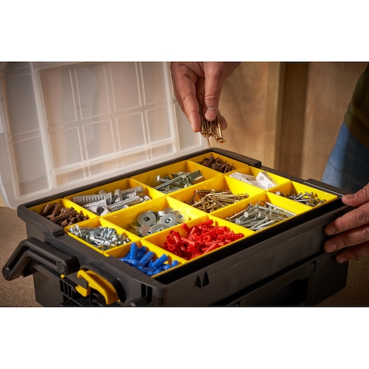 STANLEY STST1-75540 organizer box with yellow compartments holding assorted fasteners, top angle photo.