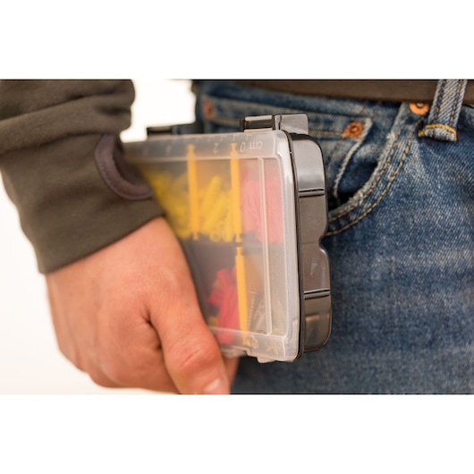 STANLEY STST81679-1 organizer held by hand, transparent lid, assorted items inside, close-up view.