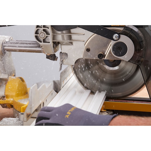 STANLEY STST82602-1 circular saw cutting white trim molding, close-up photo, product in use.