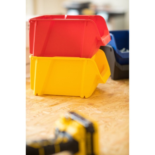 STANLEY STST82739-1 stackable red and yellow storage bins on wood surface, photography side angle.